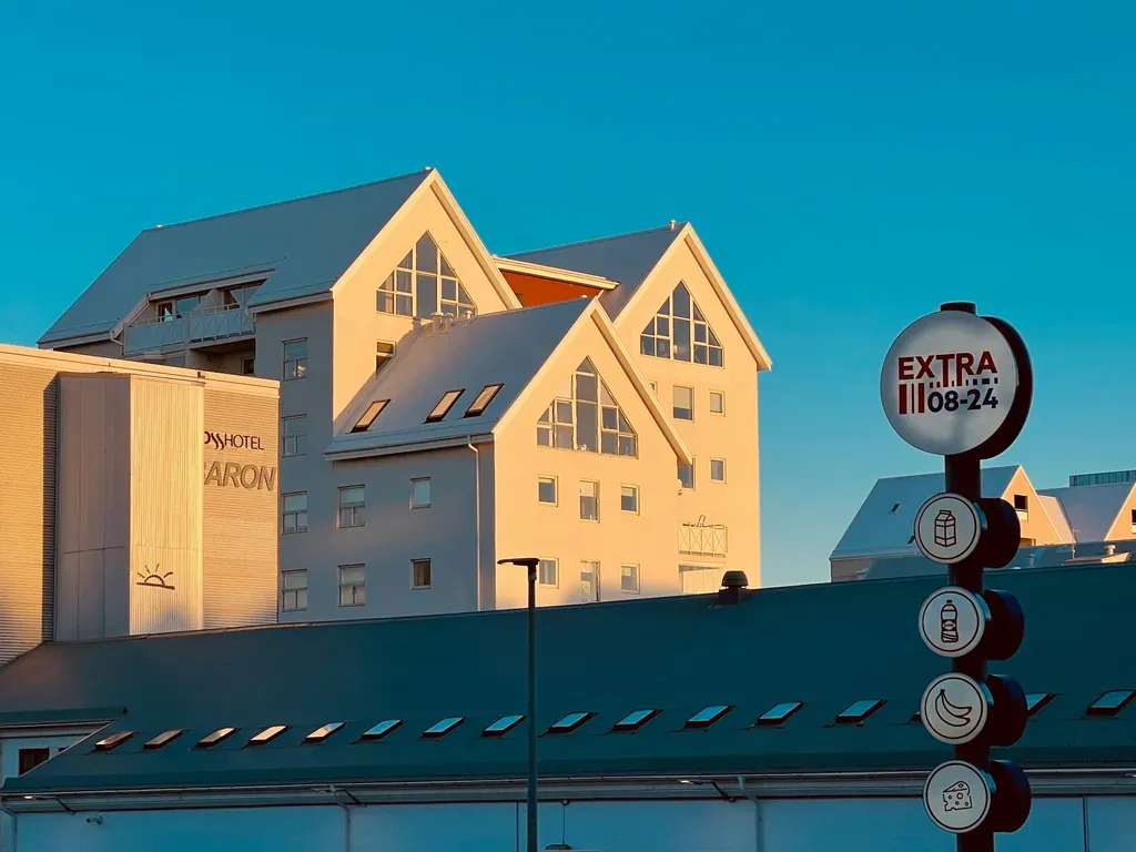 Modern buildings with snow-covered roofs under blue sky