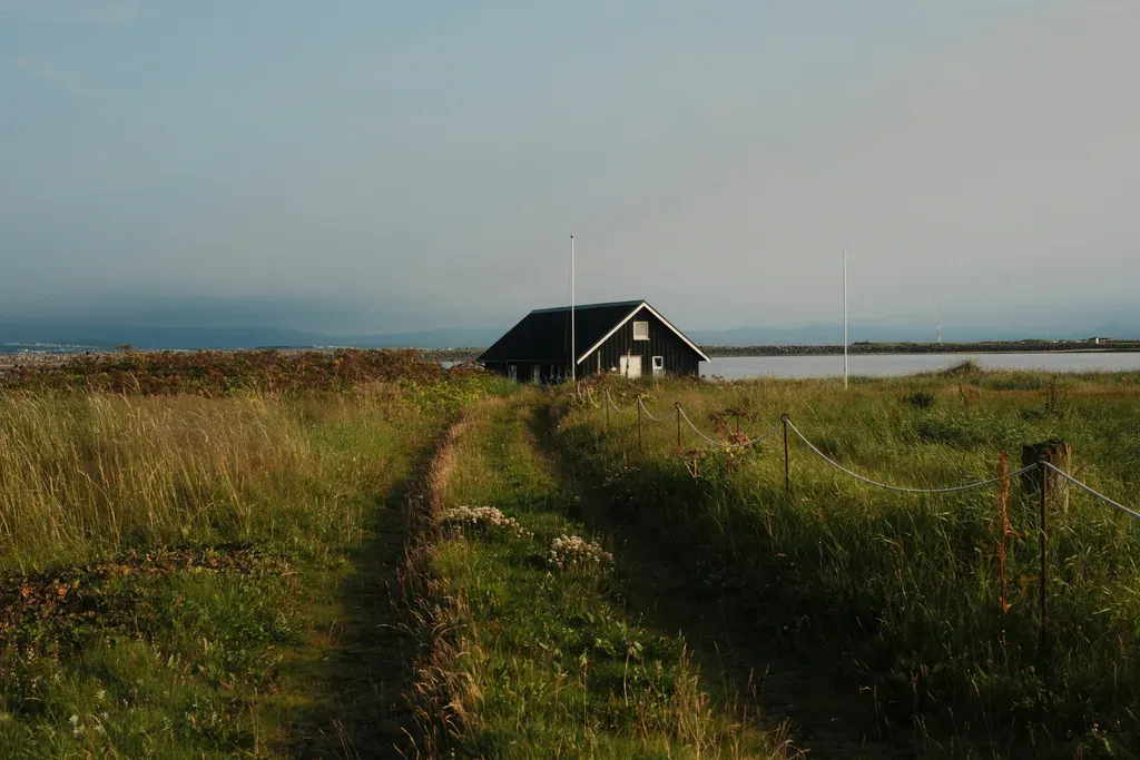 A lonely house sits in a vast field