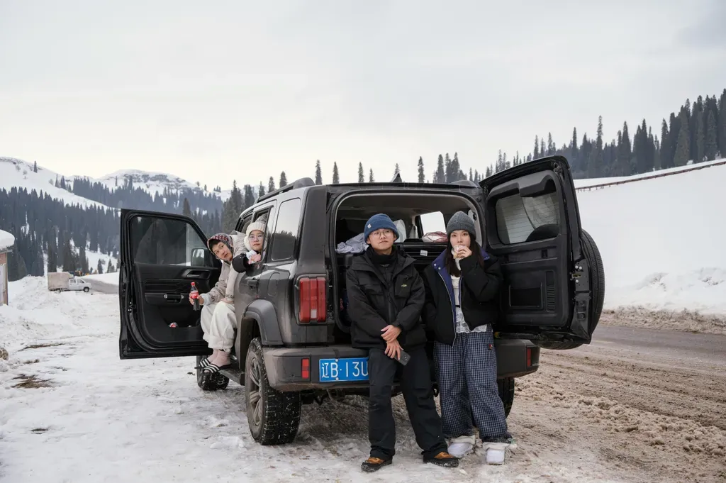 People gathered around a car in a snowy landscape