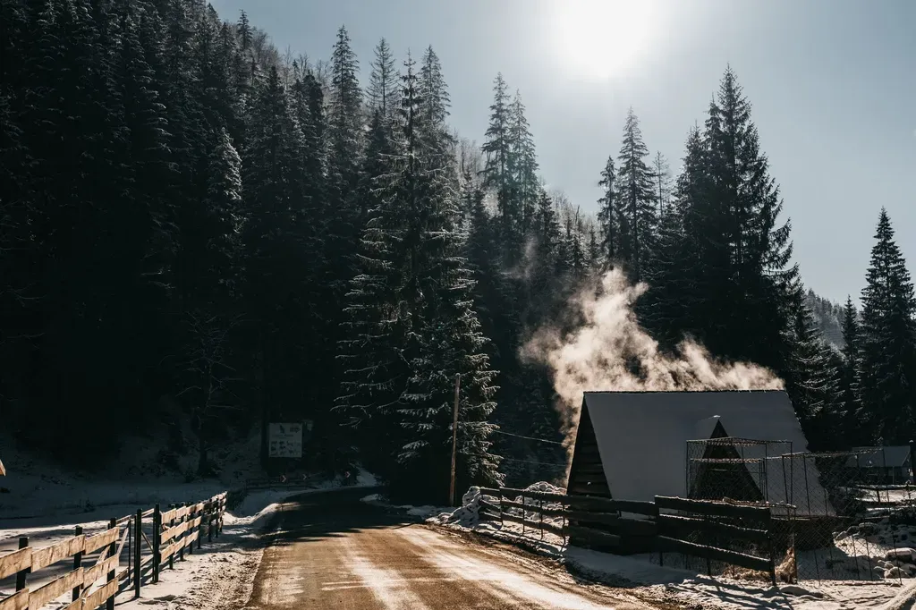 A serene winter scene with a wooden cabin and rising steam amidst a snowy forest.