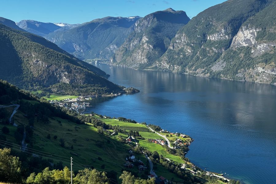 beautiful-green-grass-next-to-lake-and-mountains.jpg